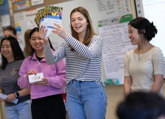 Individual holds up pamflets