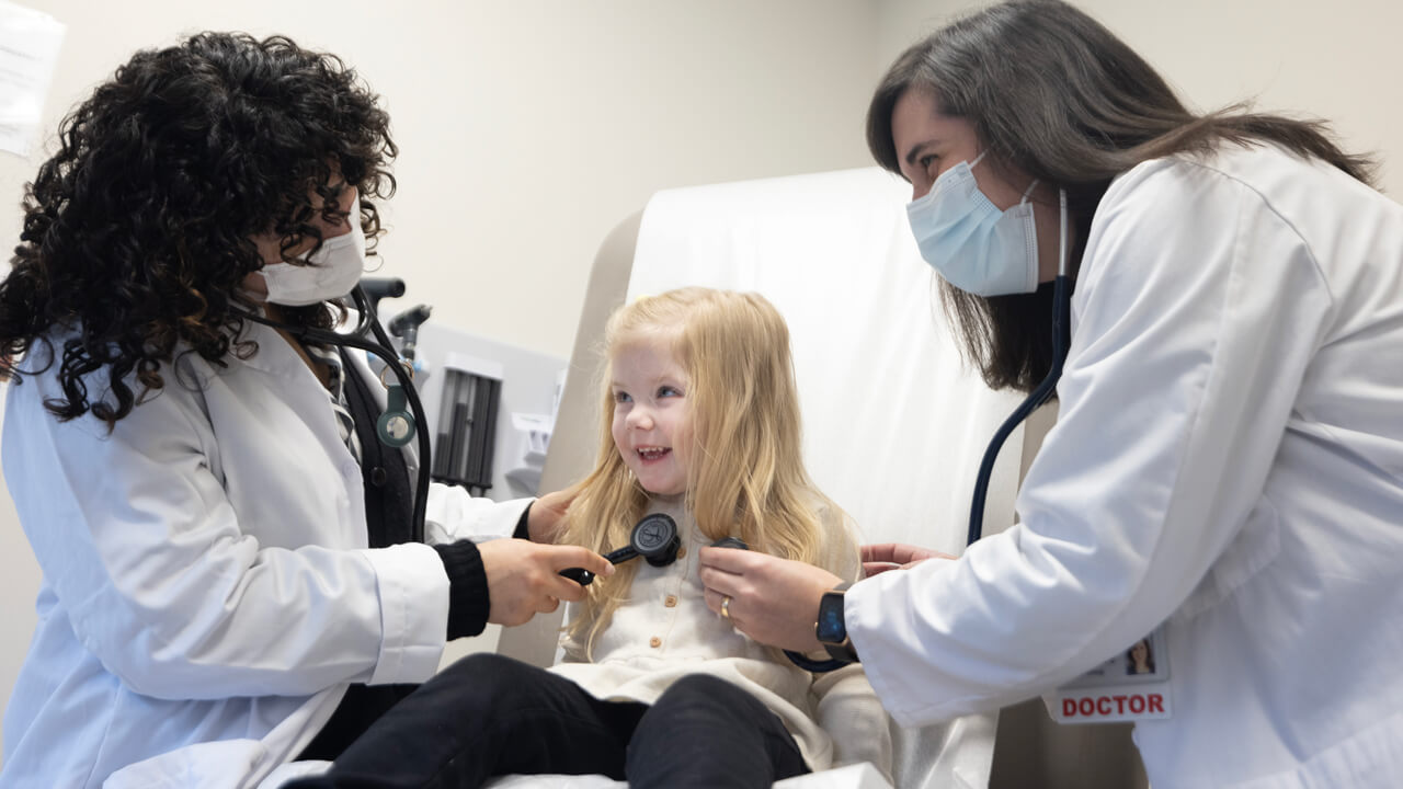 Doctors perform an exam on a child.