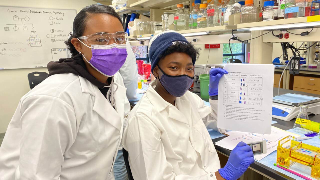 Student and supervisor show results of their science experiment.