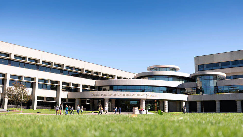 Outdoor shot of the Center for Medicine, Nursing and Health Sciences under a blue sky